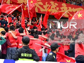 Fans cheer for China during their football match against Indonesia in the fourth round of the World Cup Qualifiers in Qingdao, China, on Oct...