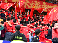 Fans cheer for China during their football match against Indonesia in the fourth round of the World Cup Qualifiers in Qingdao, China, on Oct...