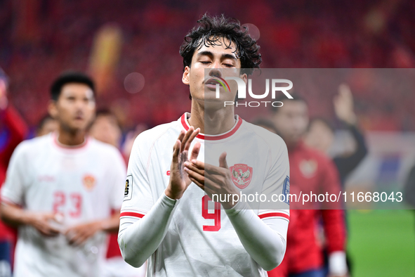 Indonesia players greet during the Chinese football team's match against Indonesia in the 4th round of the World Qualifiers Asian Zone in Qi...