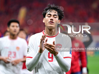 Indonesia players greet during the Chinese football team's match against Indonesia in the 4th round of the World Qualifiers Asian Zone in Qi...