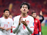 Indonesia players greet during the Chinese football team's match against Indonesia in the 4th round of the World Qualifiers Asian Zone in Qi...