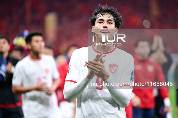 Indonesia players greet during the Chinese football team's match against Indonesia in the 4th round of the World Qualifiers Asian Zone in Qi...