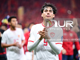 Indonesia players greet during the Chinese football team's match against Indonesia in the 4th round of the World Qualifiers Asian Zone in Qi...