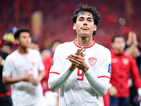 Indonesia players greet during the Chinese football team's match against Indonesia in the 4th round of the World Qualifiers Asian Zone in Qi...