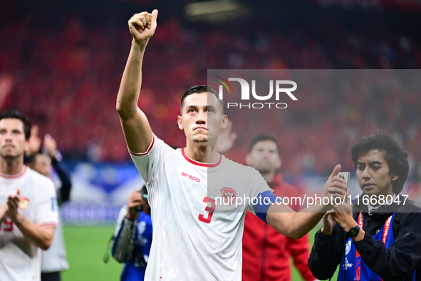 Indonesia players greet during the Chinese football team's match against Indonesia in the 4th round of the World Qualifiers Asian Zone in Qi...