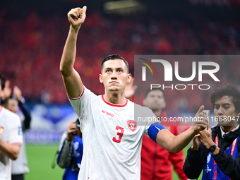 Indonesia players greet during the Chinese football team's match against Indonesia in the 4th round of the World Qualifiers Asian Zone in Qi...