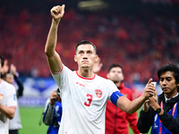 Indonesia players greet during the Chinese football team's match against Indonesia in the 4th round of the World Qualifiers Asian Zone in Qi...