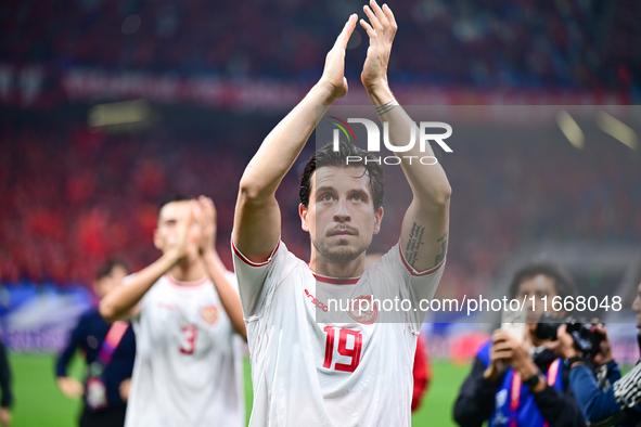 Indonesia players greet during the Chinese football team's match against Indonesia in the 4th round of the World Qualifiers Asian Zone in Qi...