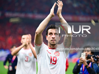 Indonesia players greet during the Chinese football team's match against Indonesia in the 4th round of the World Qualifiers Asian Zone in Qi...