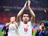 Indonesia players greet during the Chinese football team's match against Indonesia in the 4th round of the World Qualifiers Asian Zone in Qi...