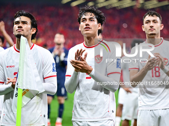 Indonesia players greet during the Chinese football team's match against Indonesia in the 4th round of the World Qualifiers Asian Zone in Qi...