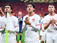 Indonesia players greet during the Chinese football team's match against Indonesia in the 4th round of the World Qualifiers Asian Zone in Qi...