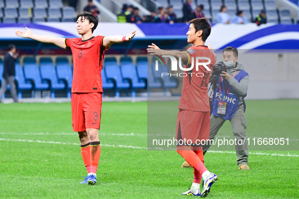 Chinese players greet during the Chinese football team's match against Indonesia in the 4th round of the World Qualifiers Asian Zone in Qing...