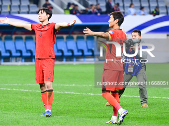 Chinese players greet during the Chinese football team's match against Indonesia in the 4th round of the World Qualifiers Asian Zone in Qing...