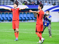 Chinese players greet during the Chinese football team's match against Indonesia in the 4th round of the World Qualifiers Asian Zone in Qing...