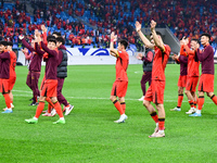 Chinese players greet during the Chinese football team's match against Indonesia in the 4th round of the World Qualifiers Asian Zone in Qing...