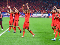 Chinese players greet during the Chinese football team's match against Indonesia in the 4th round of the World Qualifiers Asian Zone in Qing...