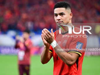 Chinese players greet during the Chinese football team's match against Indonesia in the 4th round of the World Qualifiers Asian Zone in Qing...