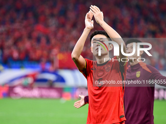 Chinese players greet during the Chinese football team's match against Indonesia in the 4th round of the World Qualifiers Asian Zone in Qing...