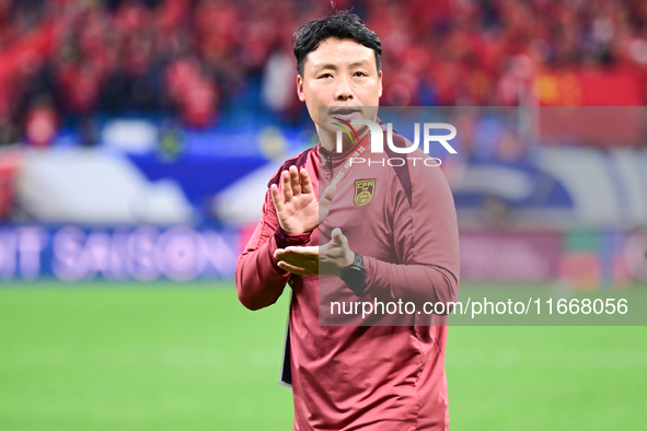 Chinese players greet during the Chinese football team's match against Indonesia in the 4th round of the World Qualifiers Asian Zone in Qing...