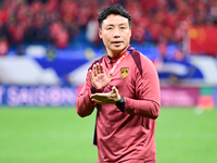 Chinese players greet during the Chinese football team's match against Indonesia in the 4th round of the World Qualifiers Asian Zone in Qing...