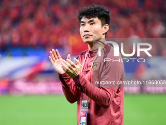 Chinese players greet during the Chinese football team's match against Indonesia in the 4th round of the World Qualifiers Asian Zone in Qing...