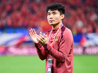 Chinese players greet during the Chinese football team's match against Indonesia in the 4th round of the World Qualifiers Asian Zone in Qing...