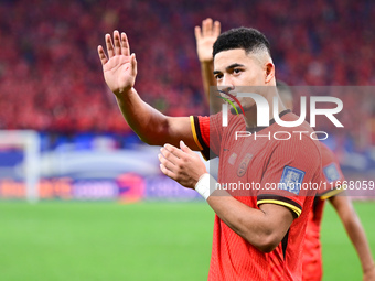 Chinese players greet during the Chinese football team's match against Indonesia in the 4th round of the World Qualifiers Asian Zone in Qing...