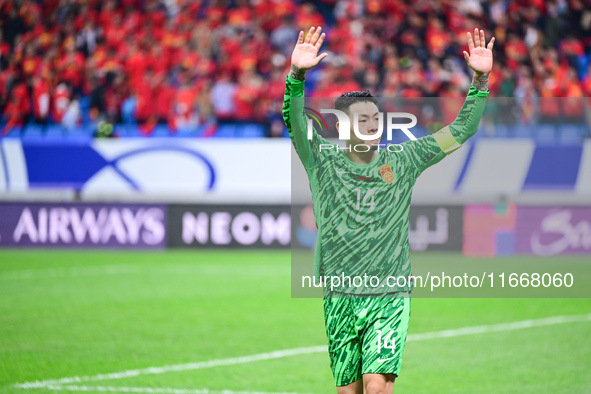 Chinese players greet during the Chinese football team's match against Indonesia in the 4th round of the World Qualifiers Asian Zone in Qing...