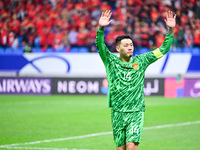 Chinese players greet during the Chinese football team's match against Indonesia in the 4th round of the World Qualifiers Asian Zone in Qing...