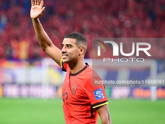 Chinese players greet during the Chinese football team's match against Indonesia in the 4th round of the World Qualifiers Asian Zone in Qing...