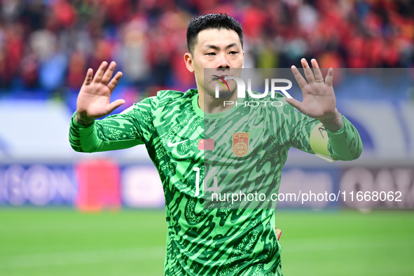 Chinese players greet during the Chinese football team's match against Indonesia in the 4th round of the World Qualifiers Asian Zone in Qing...