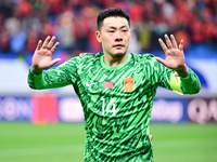 Chinese players greet during the Chinese football team's match against Indonesia in the 4th round of the World Qualifiers Asian Zone in Qing...