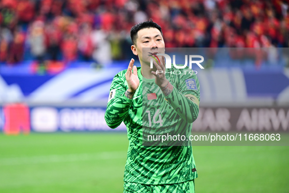 Chinese players greet during the Chinese football team's match against Indonesia in the 4th round of the World Qualifiers Asian Zone in Qing...