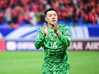 Chinese players greet during the Chinese football team's match against Indonesia in the 4th round of the World Qualifiers Asian Zone in Qing...