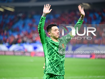 Chinese players greet during the Chinese football team's match against Indonesia in the 4th round of the World Qualifiers Asian Zone in Qing...