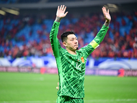 Chinese players greet during the Chinese football team's match against Indonesia in the 4th round of the World Qualifiers Asian Zone in Qing...