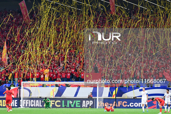 Fans cheer for China during their football match against Indonesia in the fourth round of the World Cup Qualifiers in Qingdao, China, on Oct...