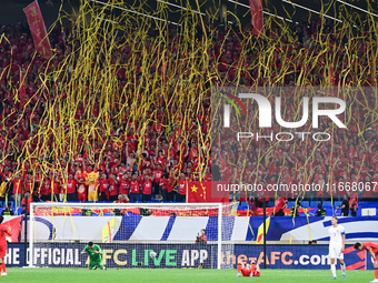 Fans cheer for China during their football match against Indonesia in the fourth round of the World Cup Qualifiers in Qingdao, China, on Oct...