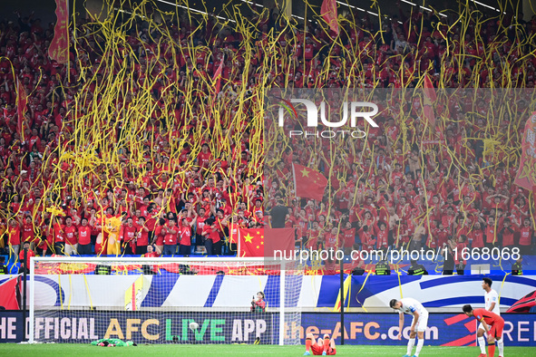 Fans cheer for China during their football match against Indonesia in the fourth round of the World Cup Qualifiers in Qingdao, China, on Oct...