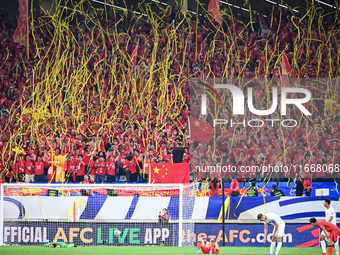 Fans cheer for China during their football match against Indonesia in the fourth round of the World Cup Qualifiers in Qingdao, China, on Oct...