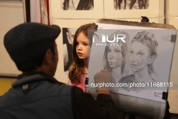 An artist sketches a little girl during the 180th annual Markham Fall Fair in Markham, Ontario, Canada, on October 5, 2024. 