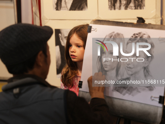 An artist sketches a little girl during the 180th annual Markham Fall Fair in Markham, Ontario, Canada, on October 5, 2024. (