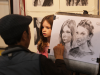 An artist sketches a little girl during the 180th annual Markham Fall Fair in Markham, Ontario, Canada, on October 5, 2024. (