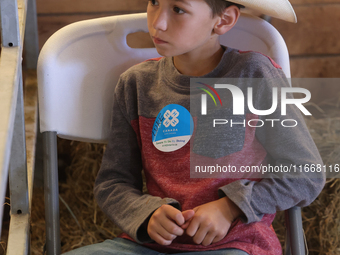 A young cowboy participates in the 180th annual Markham Fall Fair in Markham, Ontario, Canada, on October 5, 2024. (