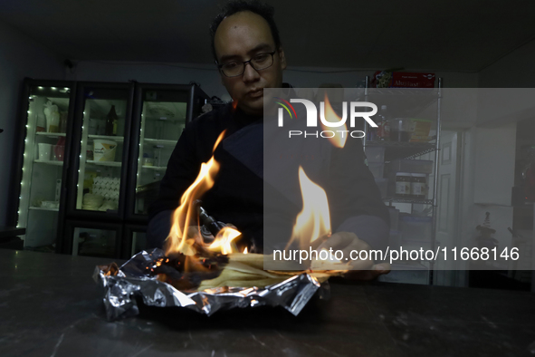 A chef burns corn husks to turn them into ashes (totomoxtle) in Mexico City, Mexico, on the eve of the Day of the Dead, to make Pan de Muert...