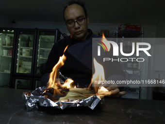 A chef burns corn husks to turn them into ashes (totomoxtle) in Mexico City, Mexico, on the eve of the Day of the Dead, to make Pan de Muert...