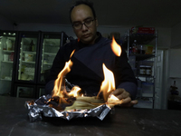 A chef burns corn husks to turn them into ashes (totomoxtle) in Mexico City, Mexico, on the eve of the Day of the Dead, to make Pan de Muert...