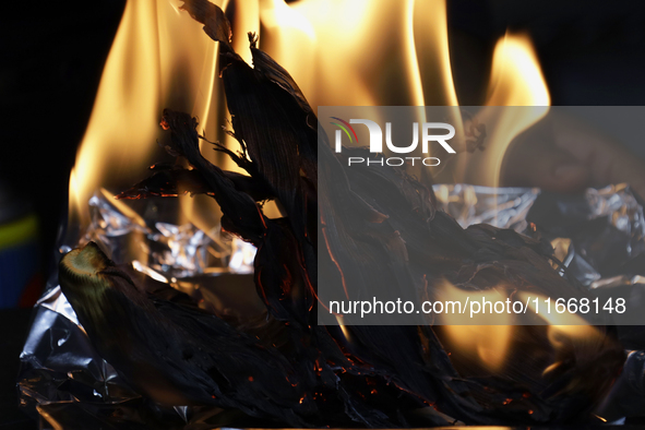 A chef burns corn husks to turn them into ashes (totomoxtle) in Mexico City, Mexico, on the eve of the Day of the Dead, to make Pan de Muert...