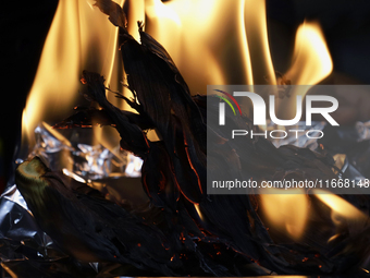 A chef burns corn husks to turn them into ashes (totomoxtle) in Mexico City, Mexico, on the eve of the Day of the Dead, to make Pan de Muert...